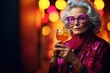 Elderly woman enjoys a colorful cocktail at summer and New Year's Eve party