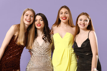 Wall Mural - Young women dressed for prom on lilac background