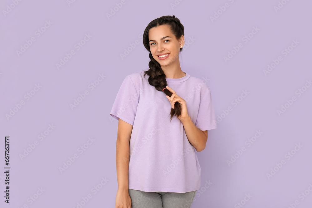 Young woman in t-shirt on lilac background