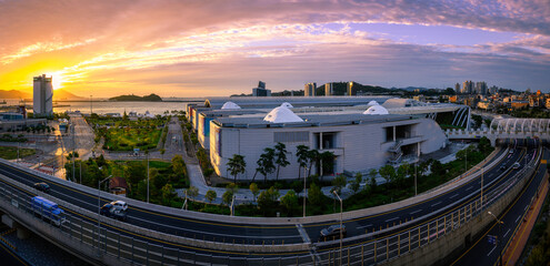 Wall Mural - Yeosu City skyline, buildings, gardens and harbor along the curving coastal overpass highway in Jeollanam-do, South Korea, panoramic cityscape at sunrise