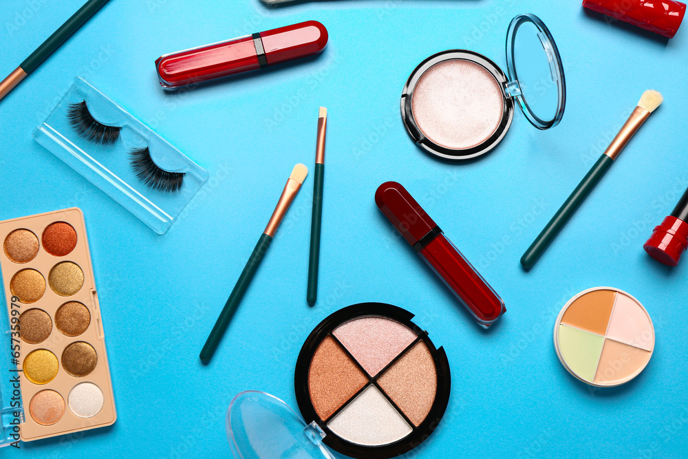 Different decorative cosmetics on blue background