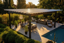 Modern Black Bio Climatic Pergola With Top View On An Outdoor Patio. Teak Wood Flooring, A Pool, And Lounge Chairs. Green Grass And Trees In A Garden