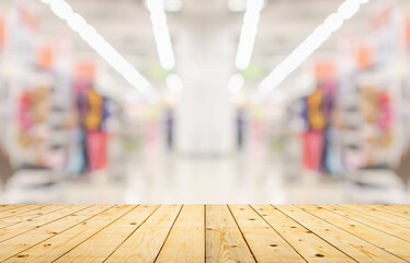 Wall Mural - Empty wood table top with supermarket blurred background for product display