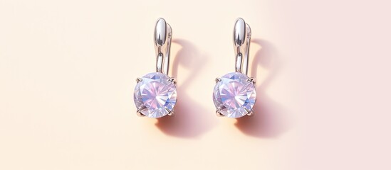 Poster - Silver sapphire earrings on a isolated pastel background Copy space with hinged lock