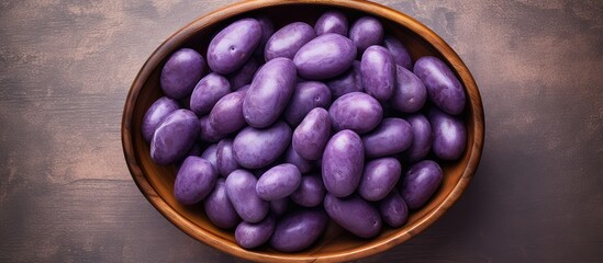 Aufkleber - Top view of isolated purple potatoes in wooden bowl isolated pastel background Copy space