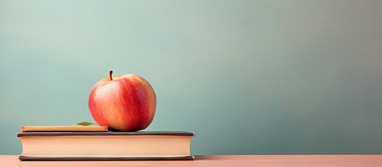 Poster - copy space image on isolated background with an apple on top of books