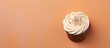 Sugary morning treat Chocolate cupcake topped with vanilla frosting isolated pastel background Copy space