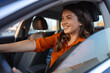 © Graphicroyalty - Beautiful young woman driving her new car at sunset. Woman in car. Close up portrait of pleasant looking female with glad positive expression, woman in casual wear driving a car
