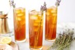 tall glasses of lavender iced tea with metal straws