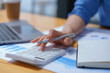 © Songsak C - Close-up portrait of businesswoman accountant using calculator and laptop for matching financial data saving in office room, Business financial, tax, accounting concept