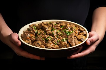 Sticker - holding a dish of freshly cooked beef stroganoff