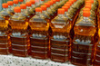 Row of bottles of fresh sunflower oil at a farmers' market. Sale of natural vegetable or palm oil