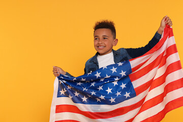 4th of July - Independence Day of USA. Happy boy with American flag on yellow background, space for text