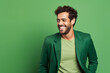 Ultra handsome man, model, smiling and laughing, wearing bright clothes. Bright solid green and yellow isolated background.