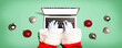 © Tierney - Santa Claus using a laptop computer with Christmas baubles from above