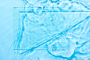 Wall Mural - Water blue surface abstract background. Waves and ripples texture of cosmetic aqua moisturizer with bubbles and transparent ice glass inside.