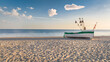 White fishing boat on beach by Baltic Sea in summer