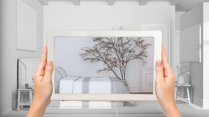 Wall Mural - augmented reality concept. hand holding tablet with ar application used to simulate furniture and de