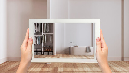 Wall Mural - augmented reality concept. hand holding tablet with ar application used to simulate furniture and de