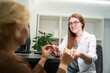 © Svitlana - Young consultant recommends a suitable frame for glasses to client