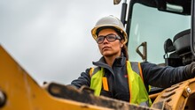 A Female Construction Worker Wearing Safety Helmet And Reflective Vest Driving A Bulldozer