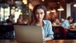 © id512 - young freelancer woman working on laptop in cafe