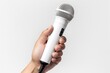Close-up of a person's hand holding microphone on white background. Generative AI.
