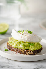avocado toast with poached egg on white background. healthy breakfast concept.