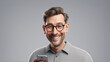 A man smiling and laughing and holding a mobile phone. Wearing glasses. Goofy man. Cheerful.
