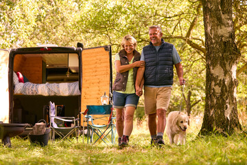 Wall Mural - Senior Couple Camping In Countryside With RV Taking Labrador Dog For A Walk