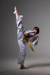 © Дмитро Петрина - A karate girl trains in a kimono with punches and kicks