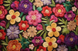 Variegated floral embroidery on black fabric pattern background 