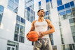 © Miljan Živković - Portrait of strong athlete man hold basketball ball wear white a-shirt