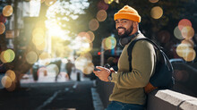 Portrait, phone and double exposure with a man on a street in the city for travel or tourism on space. Communication, backpack and a happy young traveler on an urban road to search for a location