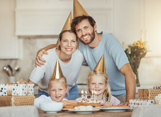 Poster - Portrait of parents, girl children and birthday cake for celebration with candles, love and sweets in home. Happiness, face of mother and father together at table at happy kids party event in house.