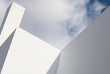 Fototapeta  - Abstract architecture. Close up of a white facade with overcast sky