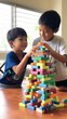 © olegganko - Two young boys building a towering skyscraper out of colorful blocks