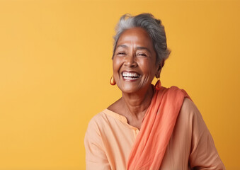 Generative AI, joyful elderly indian woman in casual stylish clothes smiling on color background, advanced age, old lady, space for text, mature people, happy pensioner, retired lifestyle