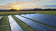 Electrical Engineer with tablet inspecting solar panels on the field at sunset