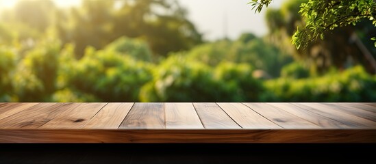 Poster - Morning view of a green garden through a blurry window with an empty wooden table suitable for product display or design visual layout