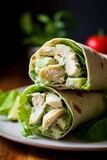 Fototapeta Kuchnia - A light and healthy chicken wrap with mayonaise and salad served on a plate, restaurant photo