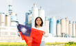 Cheerful asian girl with taiwanese flag standing in front of factory