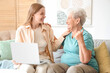 © Pixel-Shot - Senior woman with her granddaughter using laptop at home