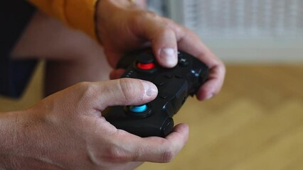 Wall Mural - Man playing on a console with a gamepad.