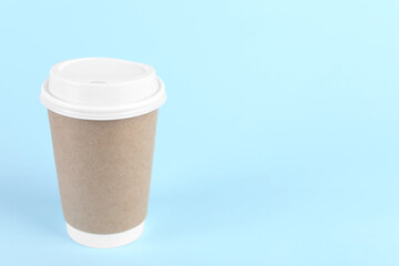 Poster - Paper cup with plastic lid on light blue background, space for text. Coffee to go