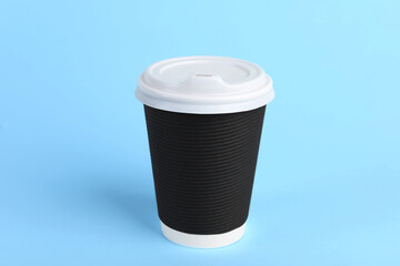 Sticker - Black paper cup with plastic lid on light blue background. Coffee to go