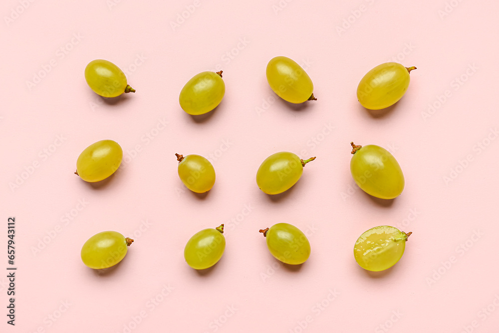 Fresh green grapes on pink background