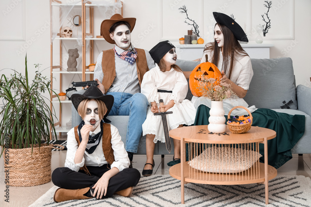 Happy family celebrating Halloween at home
