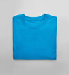 Blue folded t-shirt with on white background