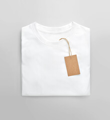 Wall Mural - White folded t-shirt with price tag label.